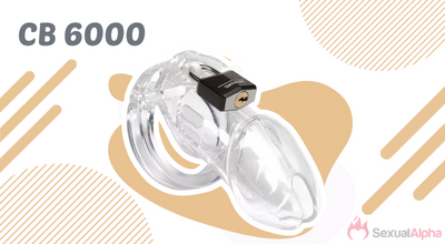 Clear plastic CB 6000 chastity device with a black padlock, displayed on a beige and white patterned background