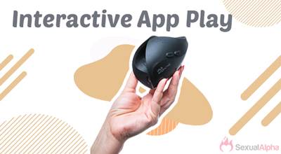 A hand holding a black interactive device against a background with abstract shapes and the text 'Interactive App Play.'